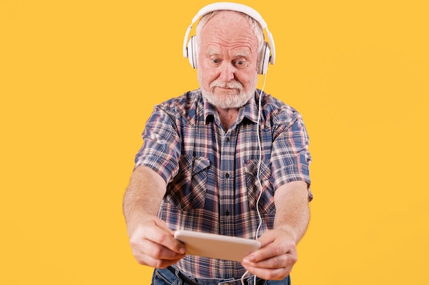 Low angle senior listening music