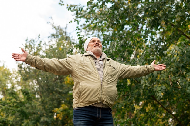 Low angle senior male with hands open for hug