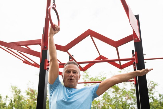 Low angle of senior man exercising outdoors