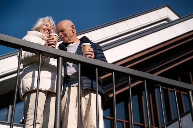 Low angle senior people with coffee cups