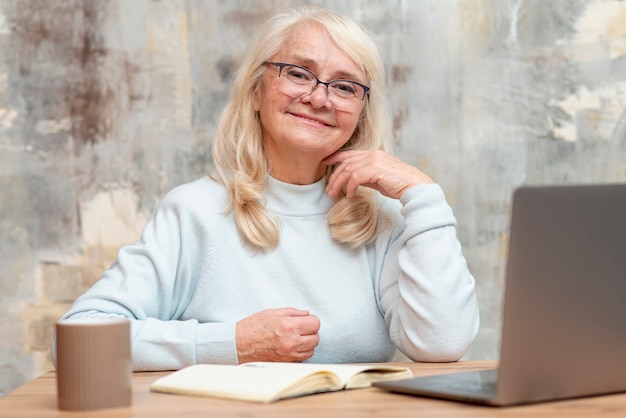 Free photo low angle senior woman at home