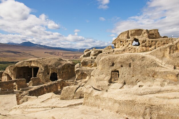 Low angle shot of the ancient rock-hewn town Uplistsikhe in Georgia