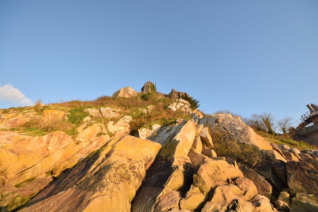 Low angle shot of the beautiful rocks captured in Le Mont Saint-Michel in France