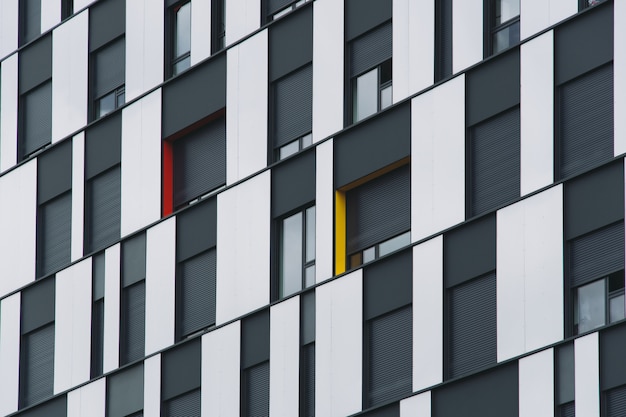 Free photo low angle shot of a black and glass facade of a modern building