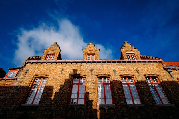 Low angle shot of a brown bricked made cathedral with windows at daytime