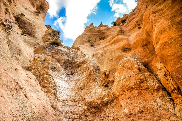 Low angle shot of cliffs under a blue sky in Umbria, Italy