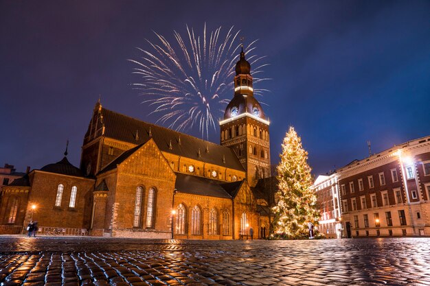 Low angle shot of the colorful fireworks on the church on a starry evening