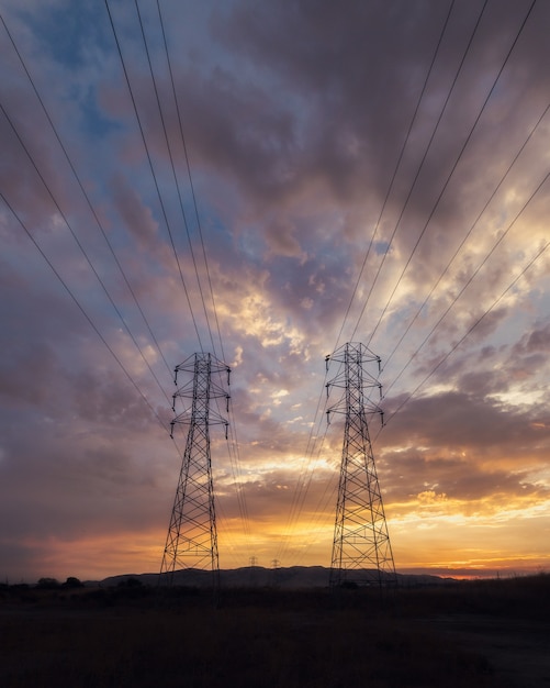Low angle shot of electricity wires under a beautiful sunset sky