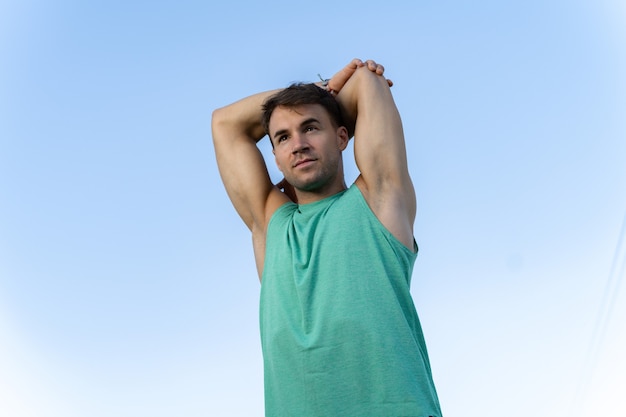 Free photo low angle shot of a handsome male doing sports