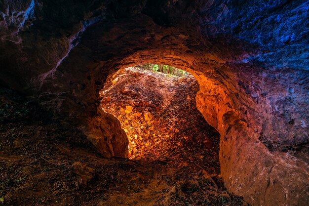 Low angle shot of a round hole as a cave entrance