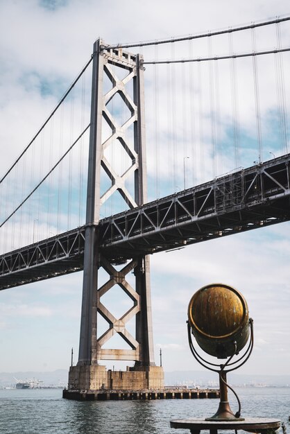 Low angle shot of the San Francisco Oakland Bay Bridge under the cloudy sky