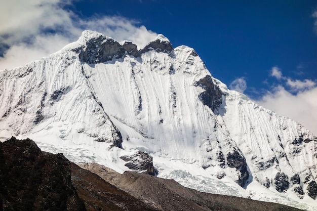 Low angle shot of the snow-covered cliffs captured on a sunny day