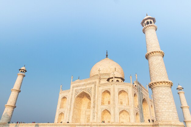 Low angle shot of the Taj Mahal mausoleum in India under a blue sky