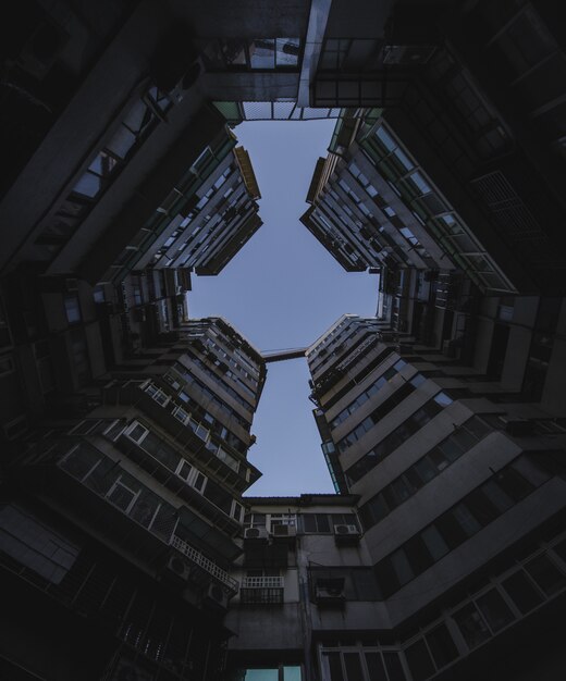 Low angle shot of tall apartment buildings under the dark sky