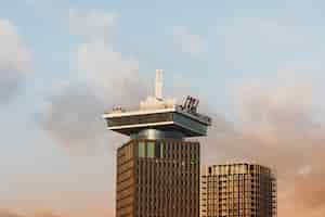 Free photo low angle shot of a tall historic building under a cloudy sky in amsterdam