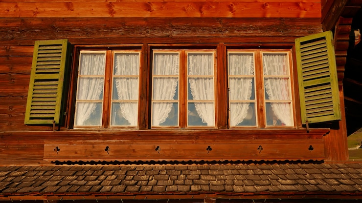 Free Photo low angle shot of vintage windows in a big house