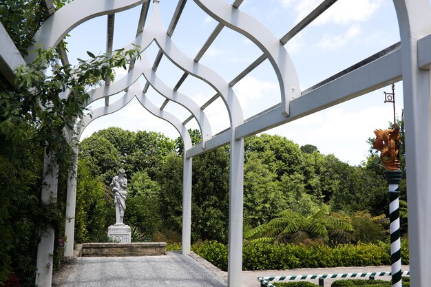 Low angle shot of a white wooden garden arch