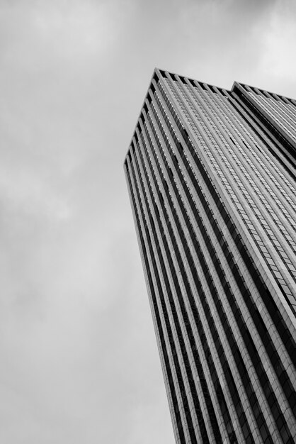 Low angle skyscraper with cloudy sky