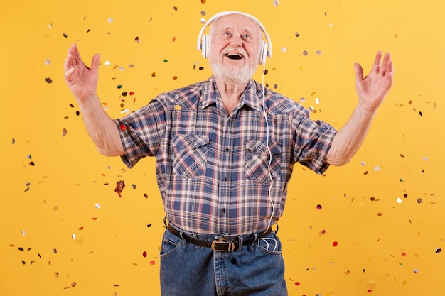 Low angle smiley senior listening music