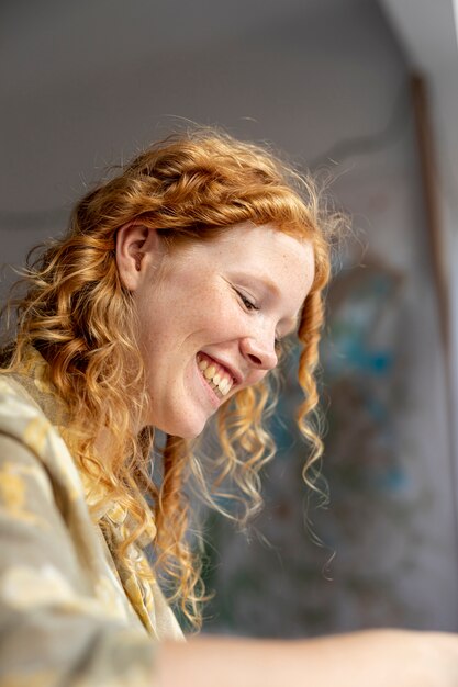 Low angle smiley woman indoors