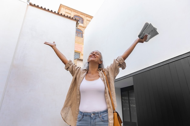 Low angle smiley woman outdoors