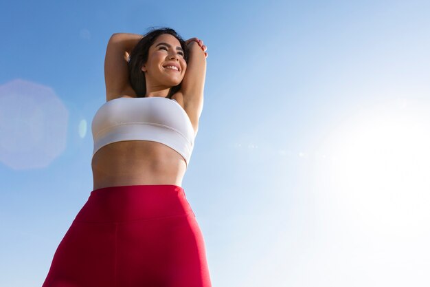 Low angle smiley woman outdoors