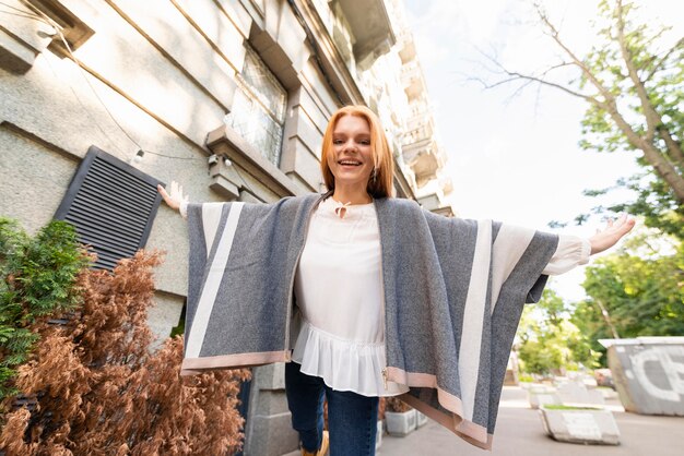 Low angle smiley woman posing