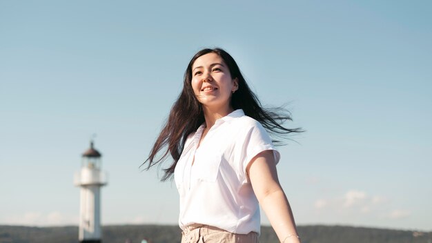 Low angle smiley woman posing