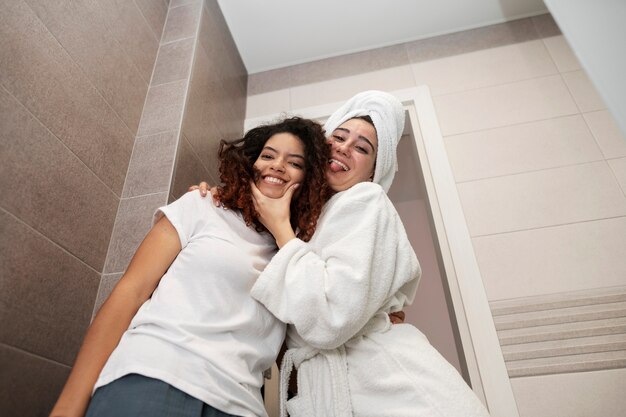 Low angle smiley women in bathroom