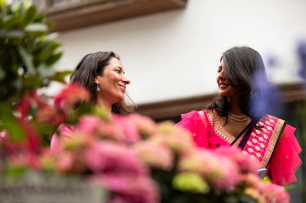 Free photo low angle smiley women in sari