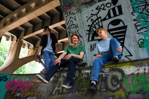 Foto gratuita adolescenti ad angolo basso con skateboard all'aperto