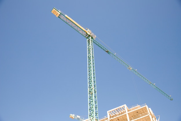 Low angle view of construction site against blue sky