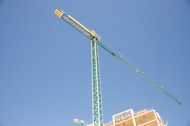 Low angle view of construction site against blue sky