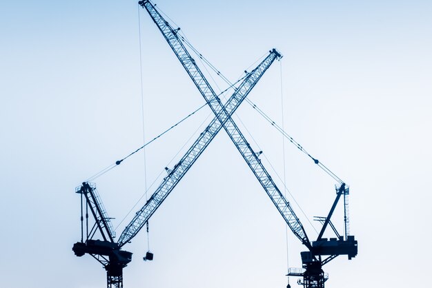 Low Angle View Of Cranes against skyline