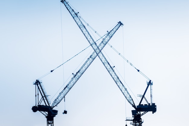 Low Angle View Of Cranes against skyline