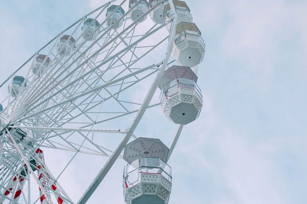 Low angle view of the Ferris Wheel carousel during daytime under a blue sky