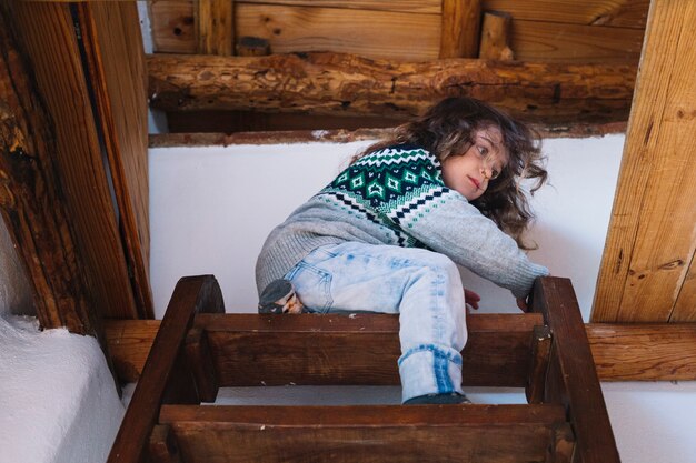 low angle view of a girl sitting on top of the staircase