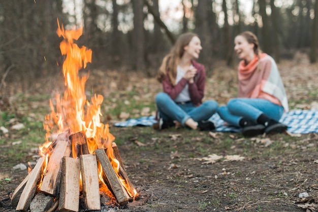 Free photo low angle woman camping with bonfire