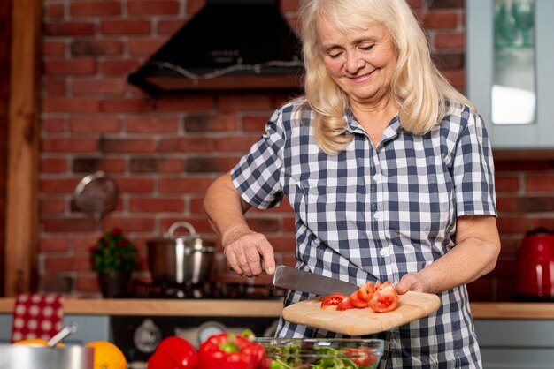 Low angle woman cooking healthy food