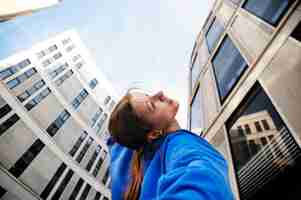 Free photo low angle woman dancing in city