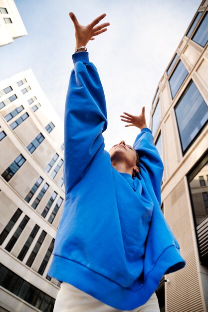 Low angle woman dancing outdoors