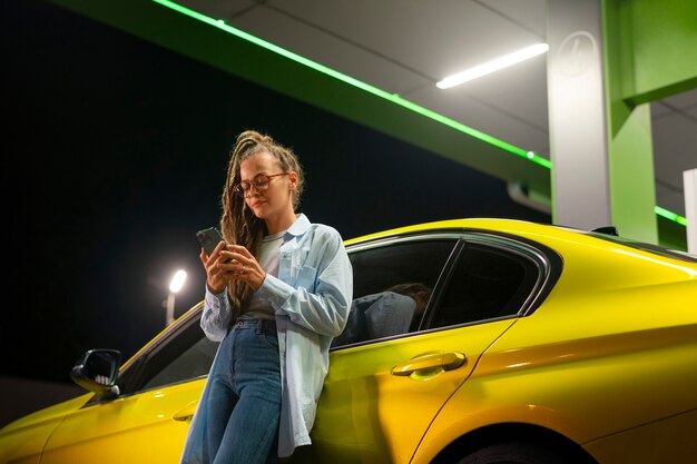 Free photo low angle woman at gas station