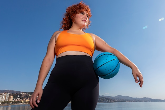 Low angle woman holding ball