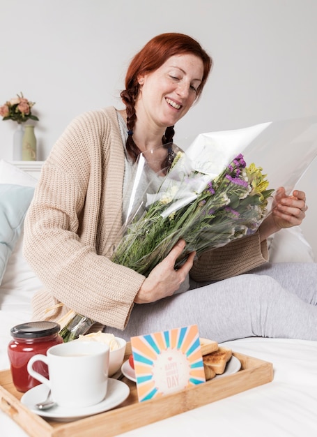 Low angle woman holding bouquet of flowers