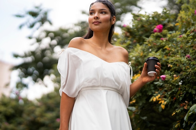 Low angle woman holding coffee cup