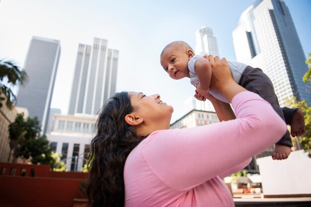 Low angle woman holding cute baby