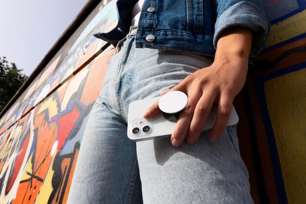 Low angle woman holding smartphone
