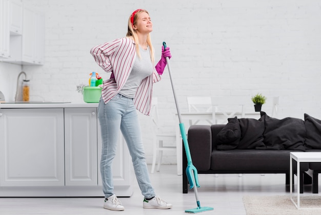 Low angle woman at home cleaning