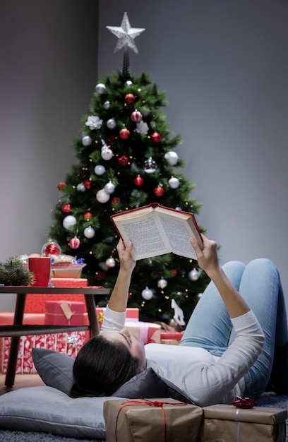 Low angle woman laid on floor reading