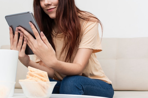 Free photo low angle of woman looking at her tablet